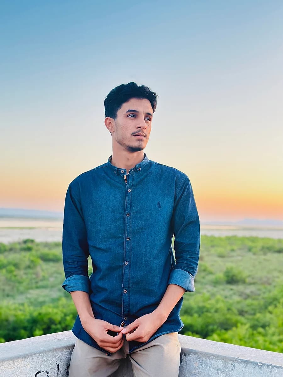 Daud at golden hour in a denim shirt